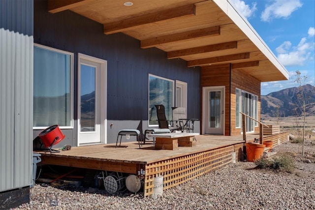 rear view of property with a deck with mountain view