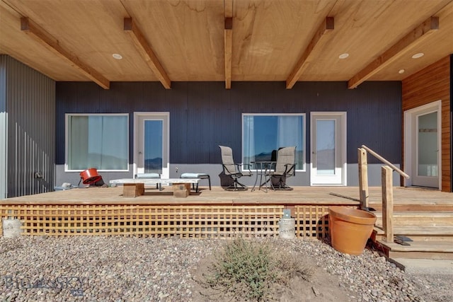 back of house with a wooden deck and outdoor dining space