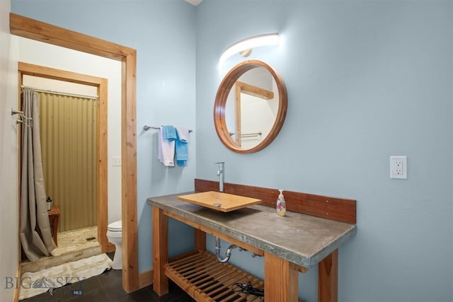 bathroom featuring a stall shower and toilet
