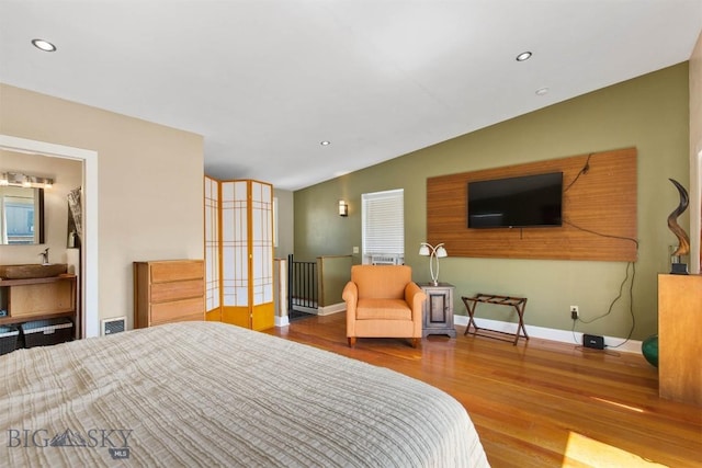 bedroom with wood finished floors, lofted ceiling, recessed lighting, and baseboards