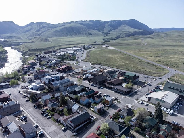 aerial view of property and surrounding area with a mountain backdrop and nearby suburban area