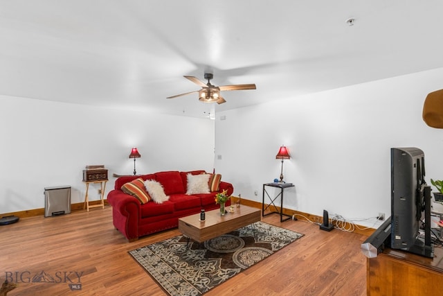 living room with ceiling fan, wood finished floors, and baseboards