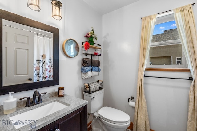 bathroom featuring toilet and vanity