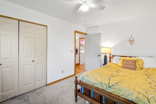 carpeted bedroom featuring a closet, washer / dryer, baseboards, and ceiling fan