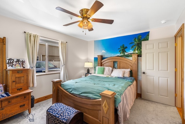 bedroom with light carpet, a ceiling fan, and baseboards