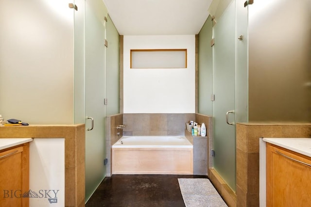 full bath with vanity, a stall shower, a garden tub, and concrete floors