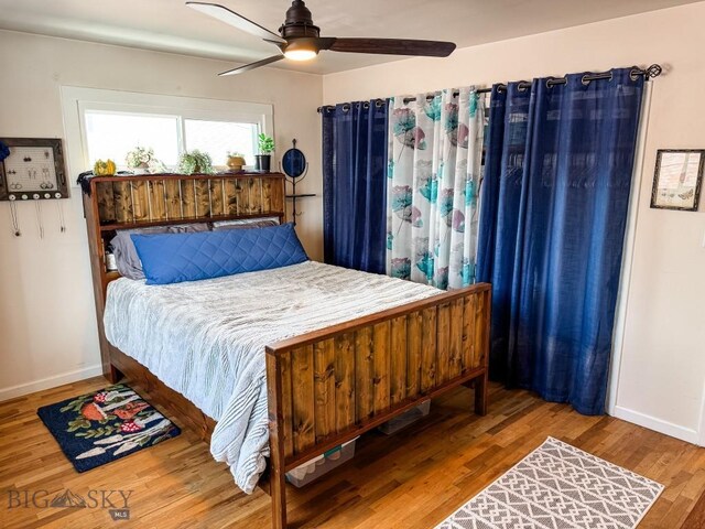 607 Meadowlark Ln, Livingston, MT 59047 - bedroom featuring baseboards, wood finished floors, and a ceiling fan