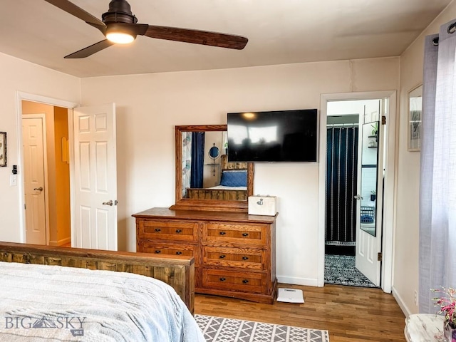 607 Meadowlark Ln, Livingston, MT 59047 - bedroom with wood finished floors, baseboards, ensuite bath, and ceiling fan