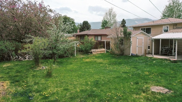 607 Meadowlark Ln, Livingston, MT 59047 - view of green lawn with a shed and an outdoor structure