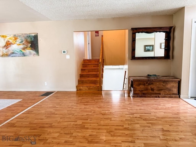 607 Meadowlark Ln, Livingston, MT 59047 - living area with wood finished floors, stairway, a textured ceiling, and baseboards