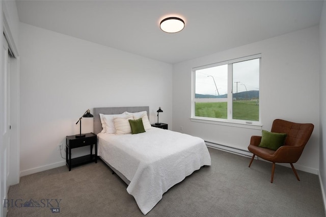 bedroom featuring carpet, a baseboard heating unit, and baseboards