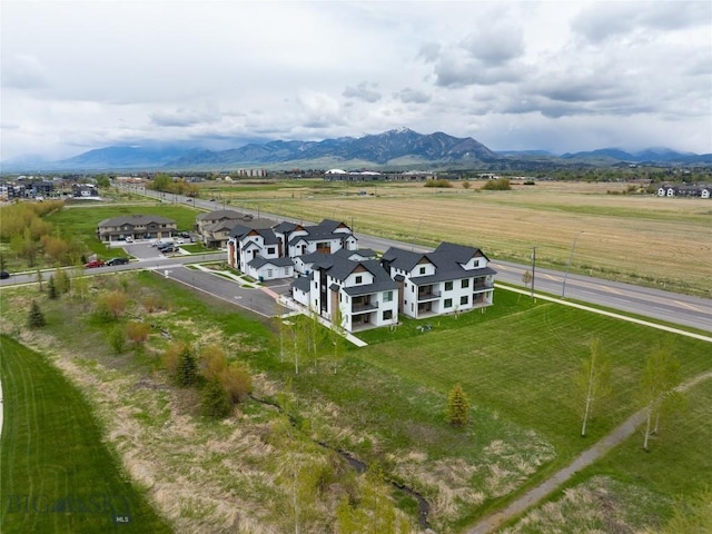 aerial view of sparsely populated area with a mountain backdrop