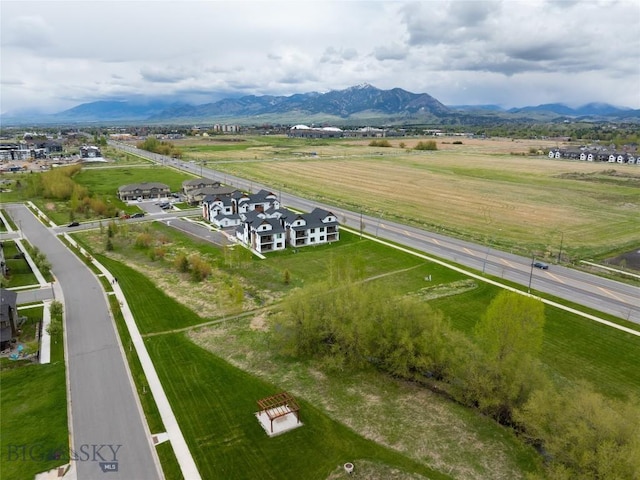 aerial view of sparsely populated area featuring a mountain backdrop