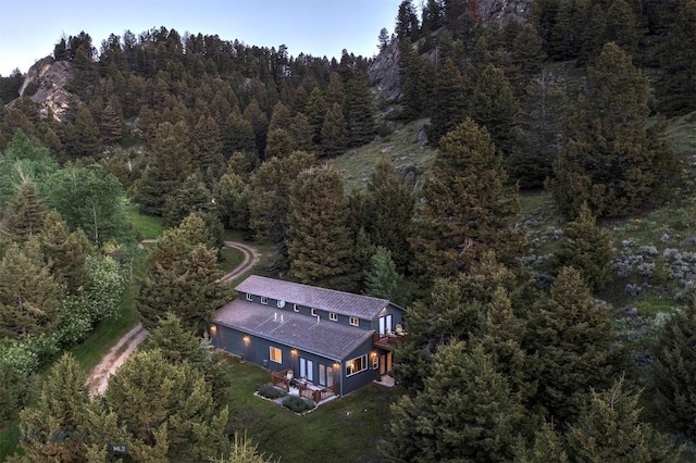 aerial view of property's location featuring a heavily wooded area