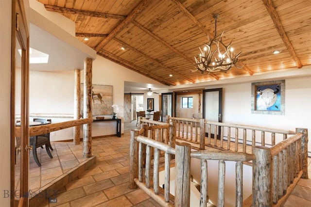 dining area with wood ceiling, a chandelier, and stone tile floors