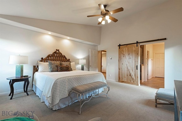 952 N Meadow Creek Rd, Mcallister, MT 59740 - carpeted bedroom with a barn door, a ceiling fan, and high vaulted ceiling
