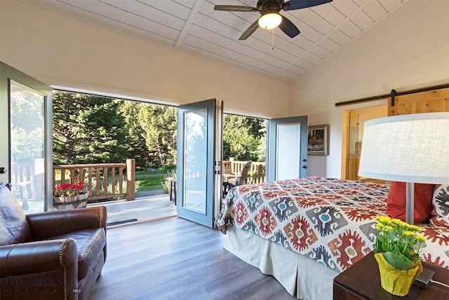 bedroom with multiple windows, access to exterior, wood finished floors, lofted ceiling, and ceiling fan