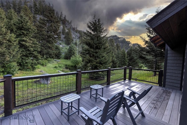 952 N Meadow Creek Rd, Mcallister, MT 59740 - wooden deck featuring a lawn and a view of trees
