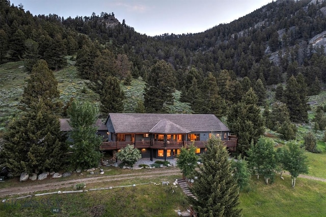 view from above of property with a forest and a mountain backdrop