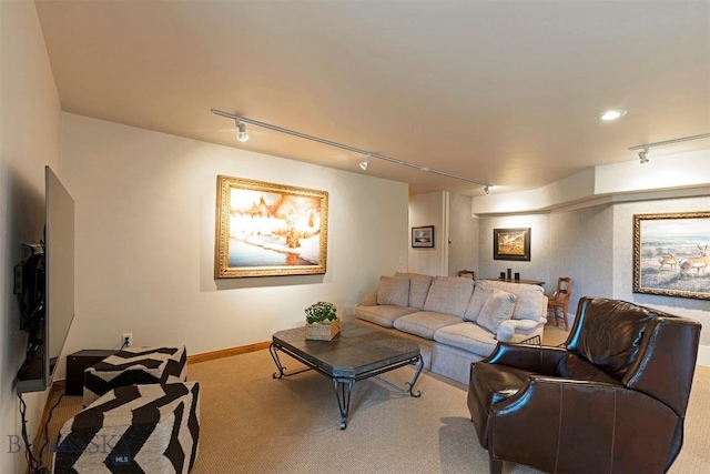living room with rail lighting, carpet, and baseboards