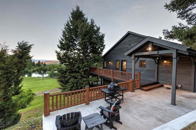 952 N Meadow Creek Rd, Mcallister, MT 59740 - wooden deck with a water view, a lawn, and a patio