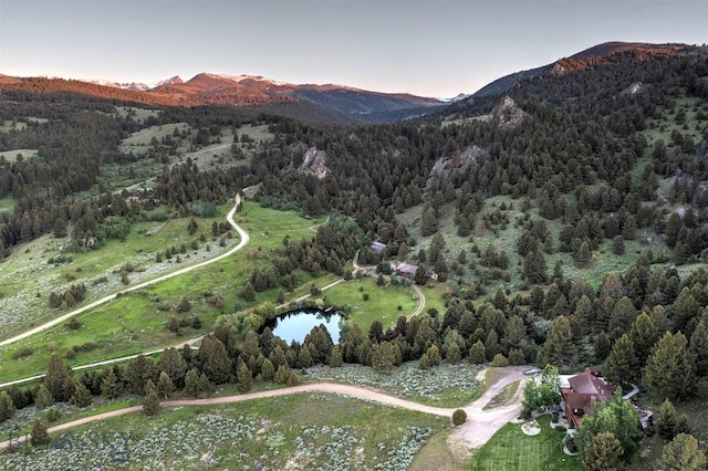 view of property location featuring mountains and a heavily wooded area