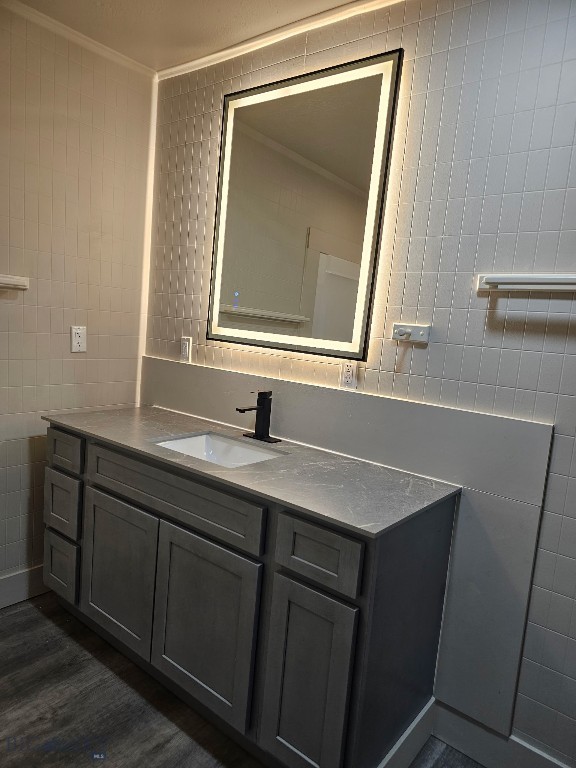 1820 Utah, Butte, MT 59701 - bathroom featuring tile walls, crown molding, vanity, and wood finished floors