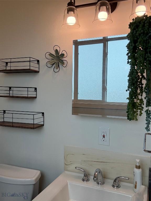 bathroom with toilet and a sink