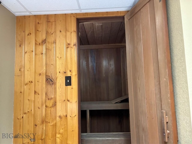 sauna / steam room with wooden walls