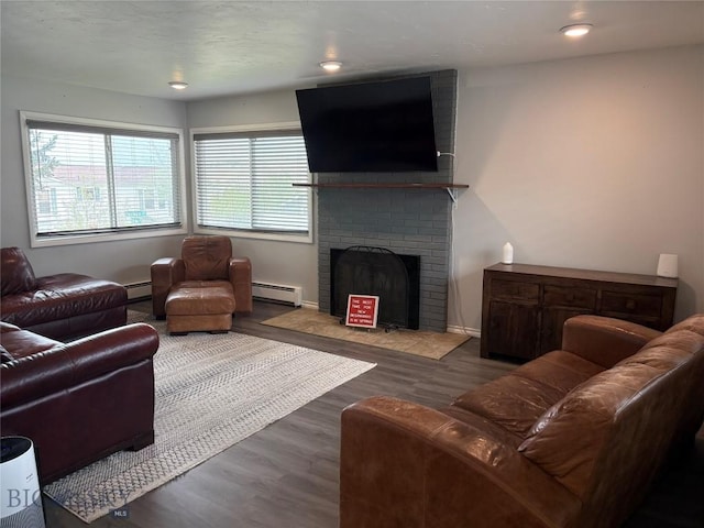 living area with a brick fireplace, wood finished floors, a baseboard radiator, and recessed lighting
