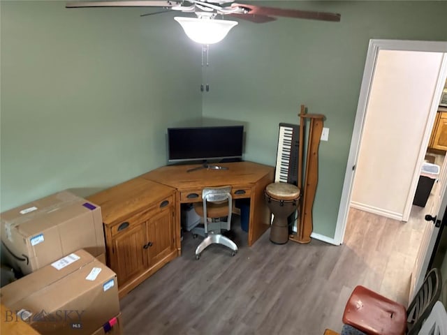 home office with ceiling fan, wood finished floors, and baseboards