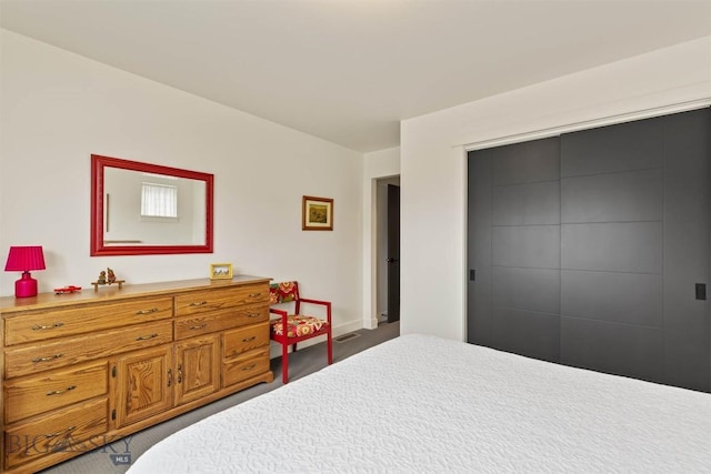 bedroom with a closet and baseboards
