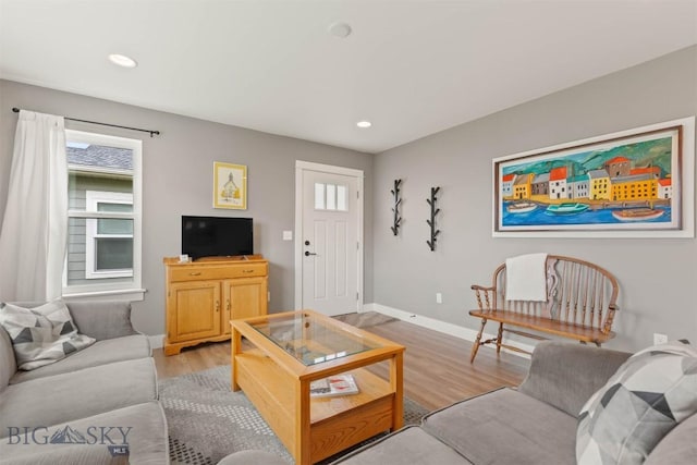 living room with baseboards, light wood-style flooring, and recessed lighting