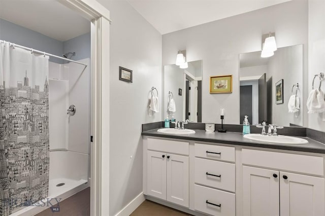 bathroom with a shower with curtain, double vanity, and baseboards