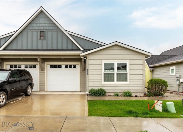 view of front of property featuring board and batten siding, concrete driveway, and a garage