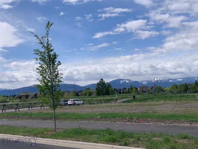 view of mountain backdrop with rural landscape