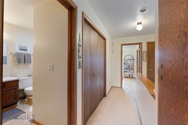 hall with light carpet and baseboards