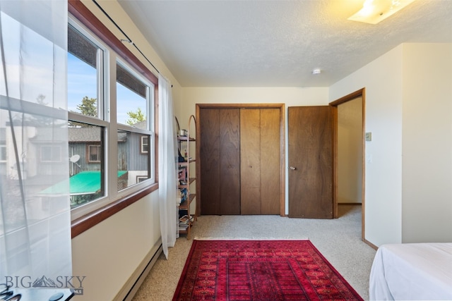 bedroom featuring carpet flooring and a textured ceiling