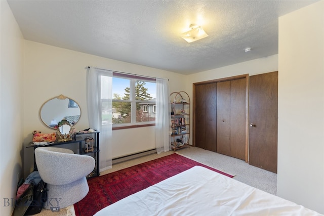 carpeted bedroom featuring a baseboard radiator, a textured ceiling, and a closet