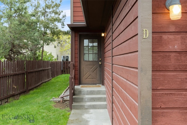 entrance to property featuring fence