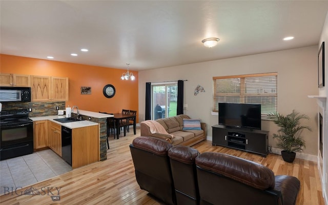 128 Droulliard Ave, Bozeman, MT 59718 - living area featuring light wood-type flooring, a chandelier, recessed lighting, and baseboards
