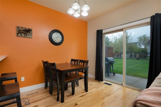 128 Droulliard Ave, Bozeman, MT 59718 - dining space featuring wood finished floors, a chandelier, and baseboards