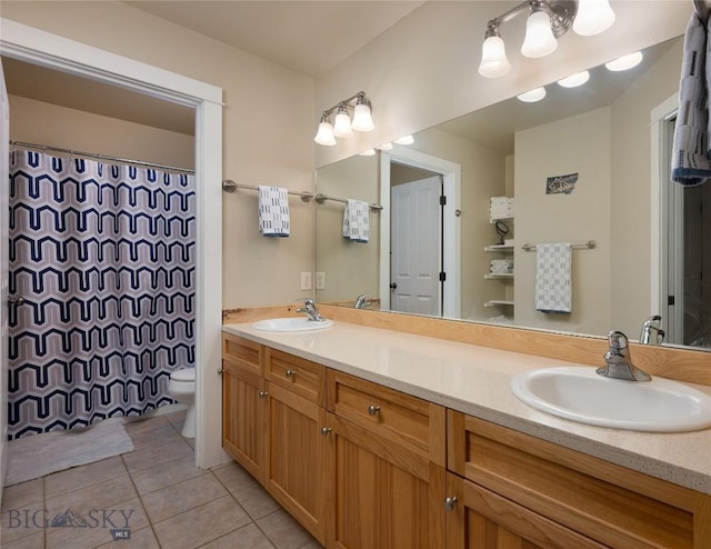 128 Droulliard Ave, Bozeman, MT 59718 - full bathroom featuring tile patterned floors, double vanity, toilet, and a shower with shower curtain