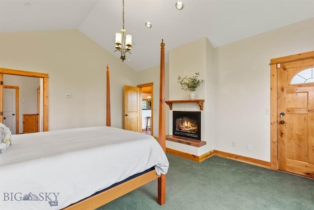 64 Shandalyn Ln, Bozeman, MT 59718 - bedroom featuring a chandelier, vaulted ceiling, carpet, a glass covered fireplace, and baseboards