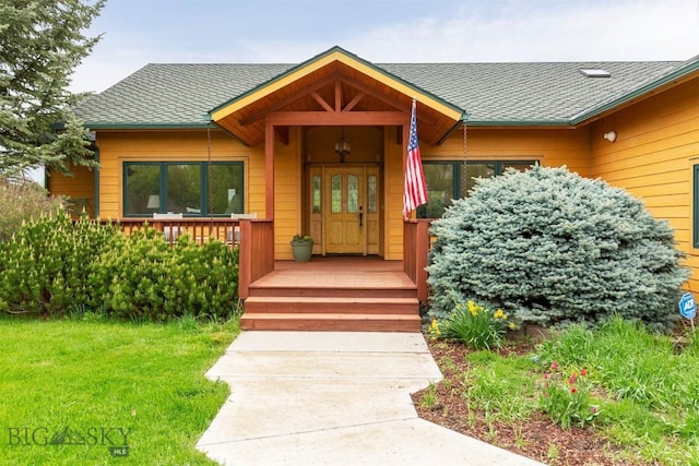 64 Shandalyn Ln, Bozeman, MT 59718 - property entrance with a shingled roof, a lawn, and a porch