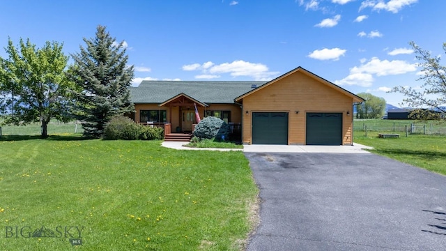 64 Shandalyn Ln, Bozeman, MT 59718 - view of front facade featuring a garage, asphalt driveway, covered porch, and roof with shingles