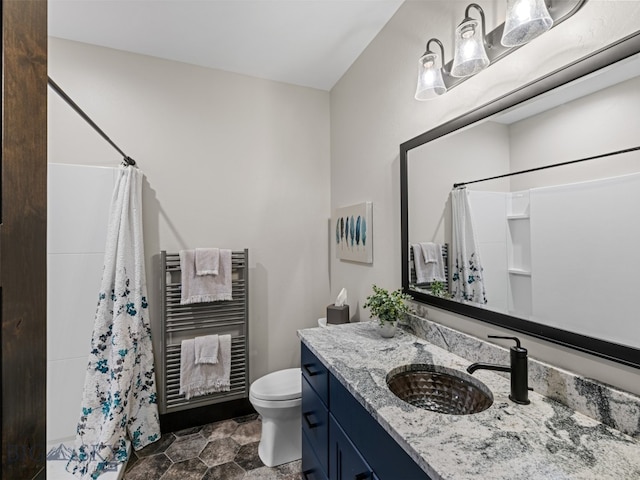 449 Minni Hall Rd, Bozeman, MT 59715 - bathroom featuring toilet, vanity, radiator, a towel warming rack, and a shower with shower curtain