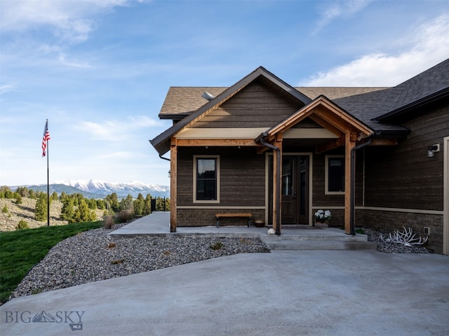 449 Minni Hall Rd, Bozeman, MT 59715 - view of front of house featuring a mountain view, stone siding, and a shingled roof