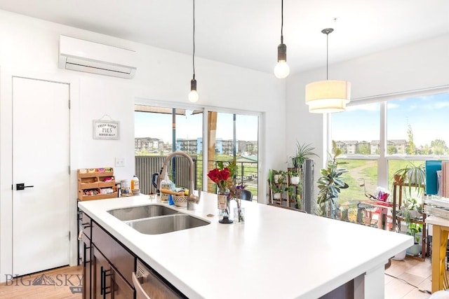 kitchen featuring a wall mounted air conditioner, a sink, light countertops, and plenty of natural light