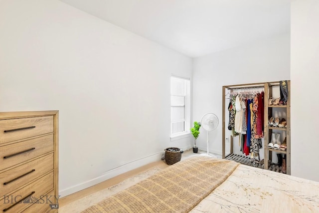 bedroom with baseboards and a closet